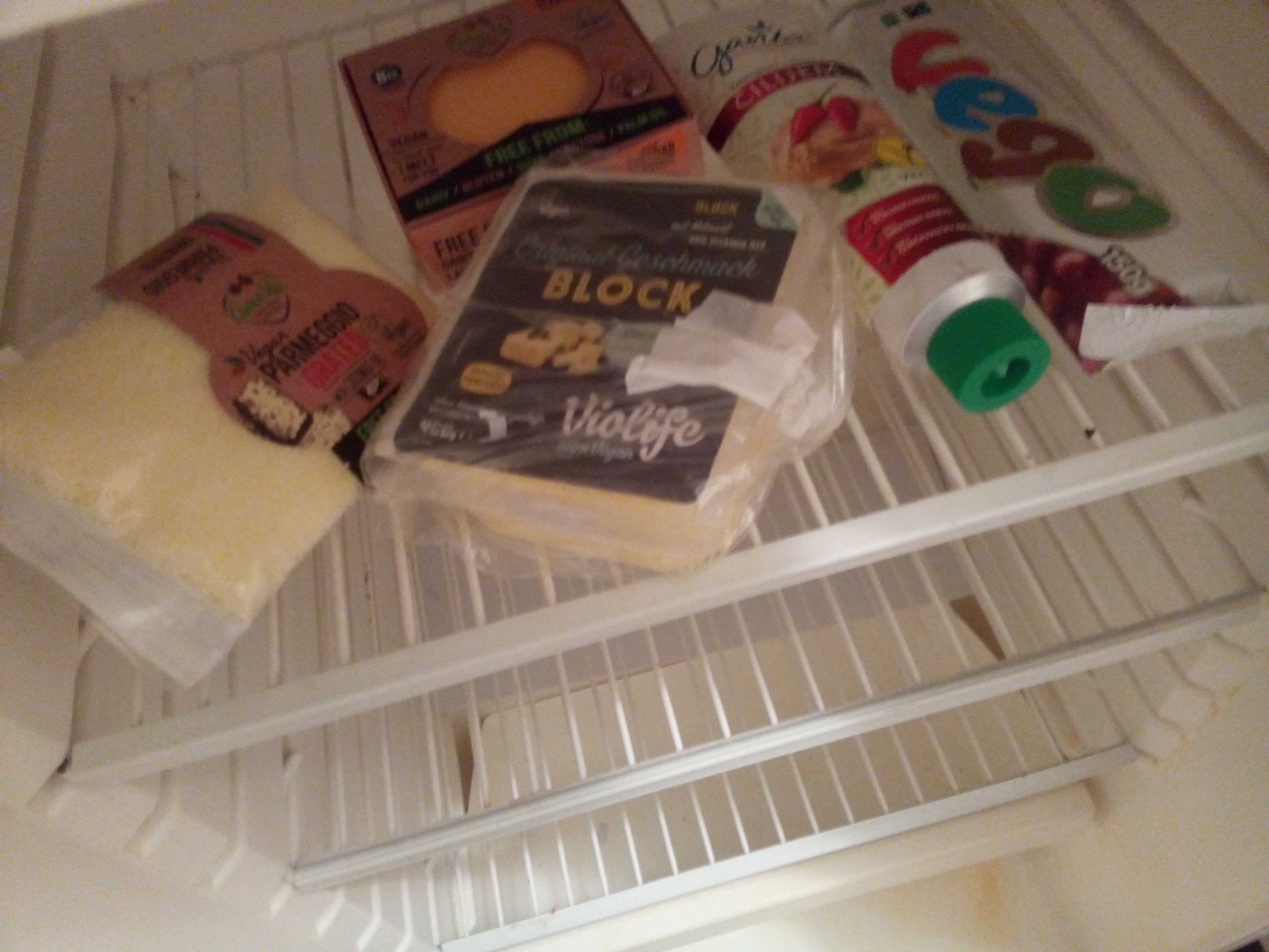 A fridge devoid of anything but vegan cheese and chocolate