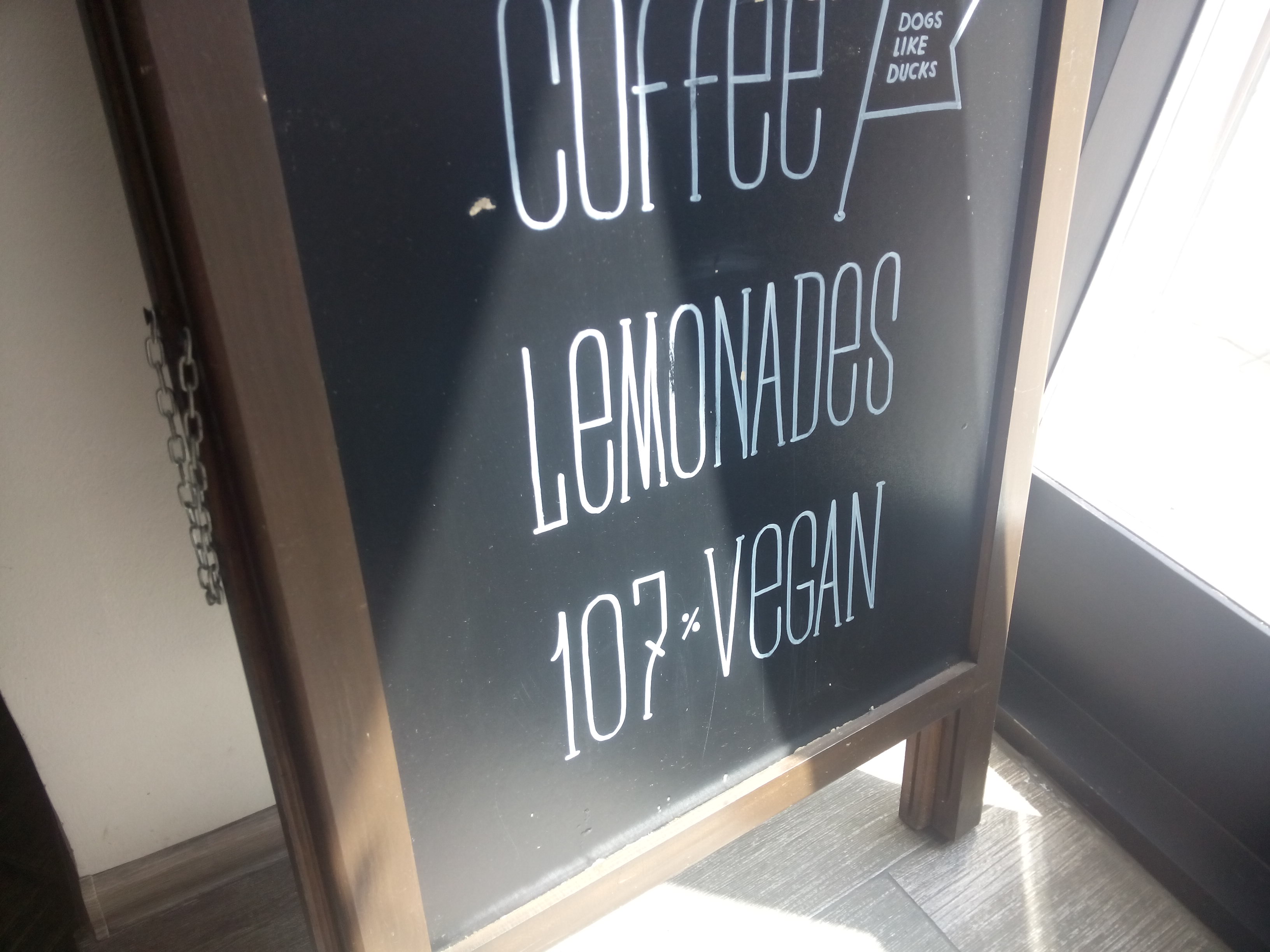 A blackboard saying 'coffee, lemonades, 107% vegan'