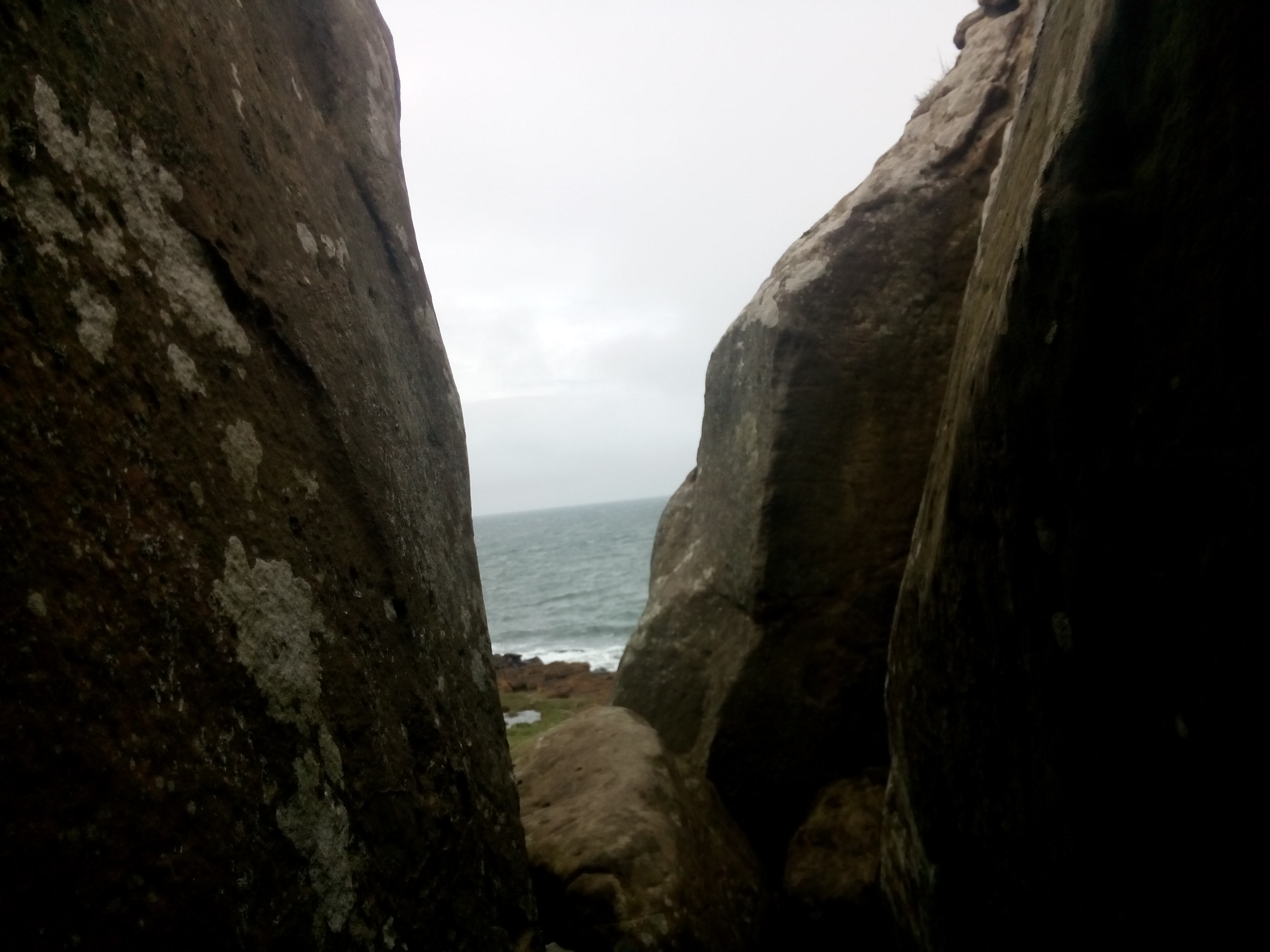 A view from between two large rocks, out to sea