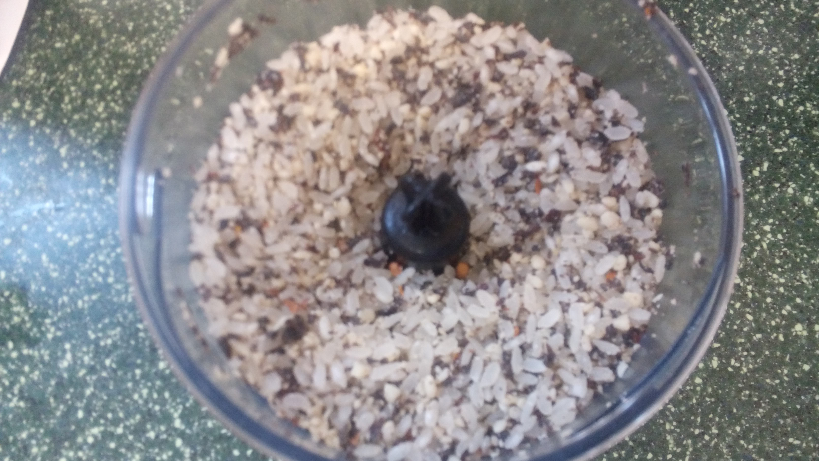 a very full food processor with rice visible on top