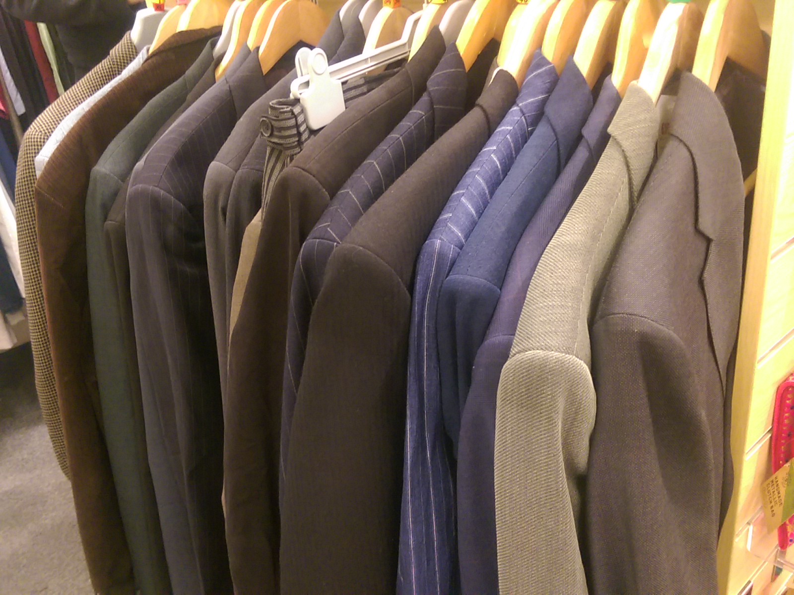 A rack of suit jackets in a shop